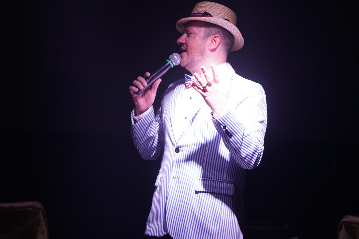 America - The Show singer in a white striped jacket and straw hat, Las Vegas